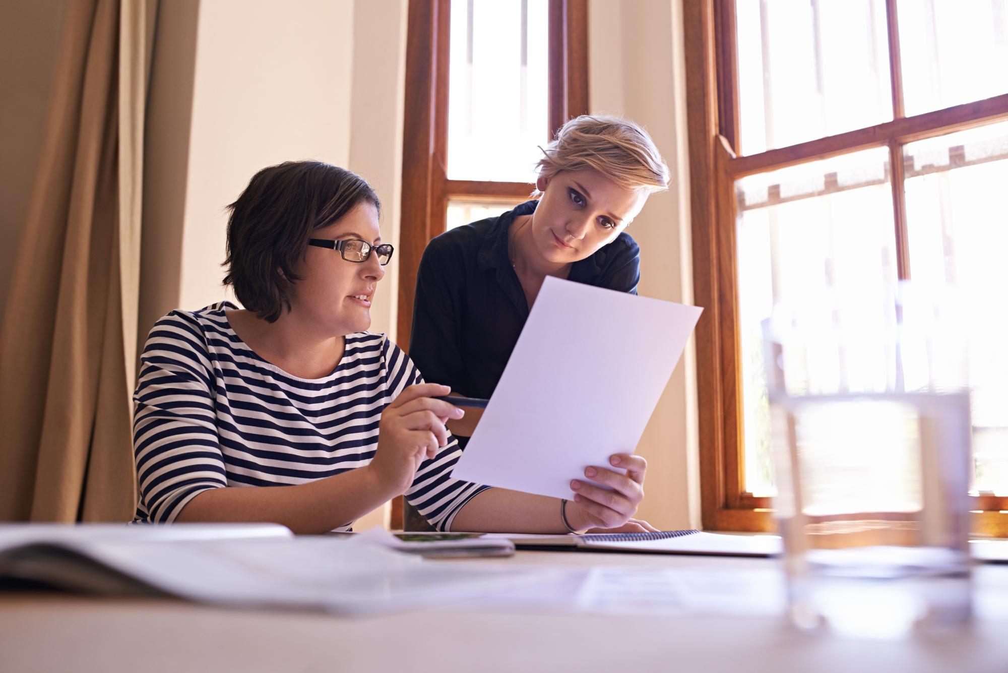 Advisor and client reviewing papers